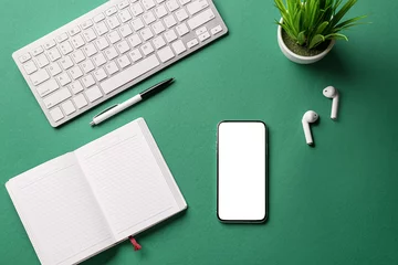 Fotobehang Mobile phone, notebook, earphones, pen and keyboard on color background © Pixel-Shot