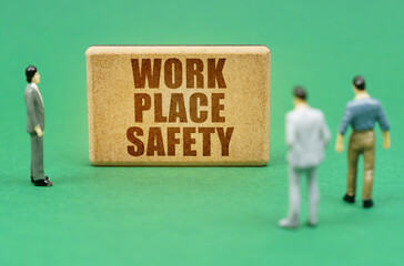 On the green surface are figures of people and a sign with the inscription - Work Place Safety