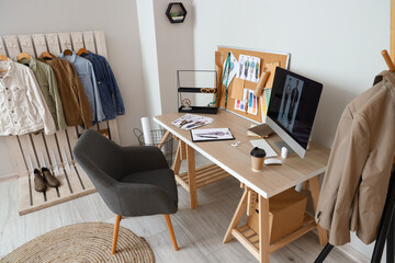 Interior of modern studio with workplace of clothes stylist