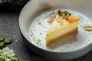 New York cheesecake or classic cheesecake with fresh berries on white plate, wooden table background and copy space for text