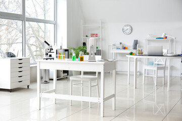 Interior of medical laboratory with modern workplace, microscope and chemical glassware