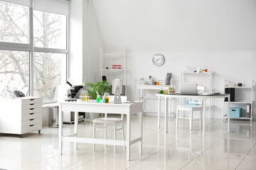 Interior of medical laboratory with modern workplace, microscope and chemical glassware