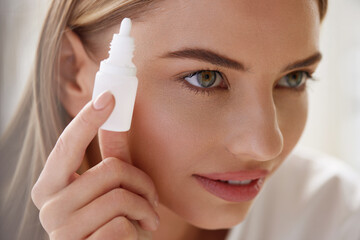 Vision And Ophthalmology Medicine. Closeup Of Beautiful Woman Applying Eyedrops In Her Eyes. Young...