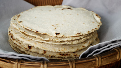 Homemade corn tortillas in a pile. Mexican traditional cuisine bread.