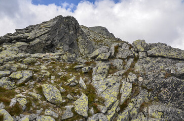 Grey stones and big boulders on the Rocky Surface against the sky with clouds at National Park High Tatras, Slovakia