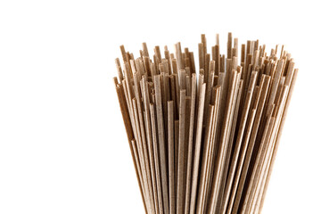 Buckwheat soba noodles in bunche, isolated on white background. Close-up.