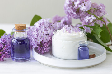Concept of pure natural organic plant-based ingredients in cosmetology, herbal and flower extract. Lilac for anti-age and anti-acne therapy, gentle face and body skin care