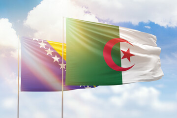 Sunny blue sky and flags of algeria and bosnia