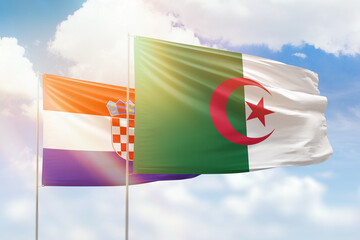 Sunny blue sky and flags of algeria and croatia