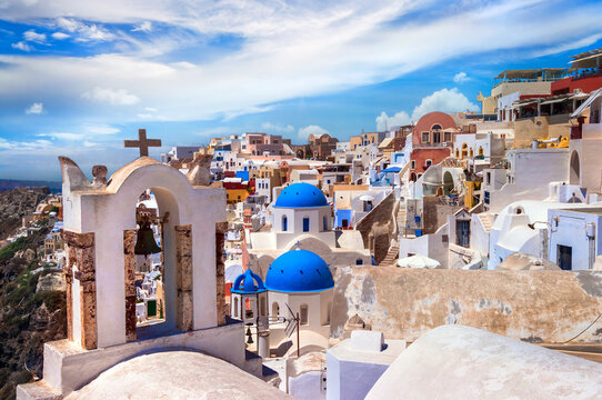Iconic view with blue domes and caldera of most beautiful island  - Santorini,  Oia village, Cyclades . Greece