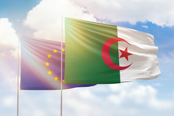 Sunny blue sky and flags of algeria and european union