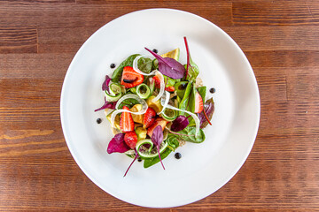 Summer Strawberry, cucumber salad with lettuce, feta cheese and almonds. Healthy Food