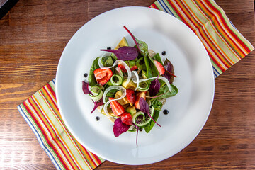 Summer Strawberry, cucumber salad with lettuce, feta cheese and almonds. Healthy Food