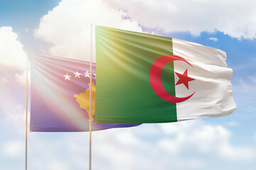 Sunny blue sky and flags of algeria and kosovo