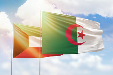 Sunny blue sky and flags of algeria and kuwait