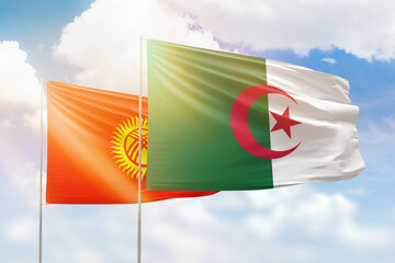 Sunny blue sky and flags of algeria and kyrgyzstan