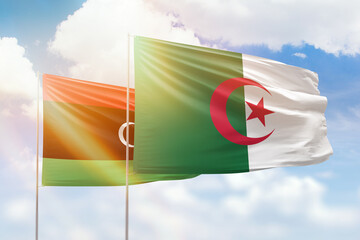 Sunny blue sky and flags of algeria and libya