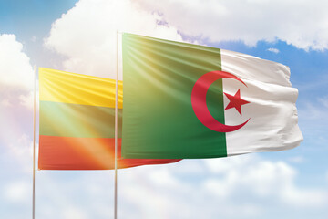 Sunny blue sky and flags of algeria and lithuania