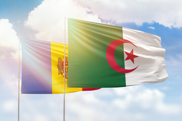 Sunny blue sky and flags of algeria and moldova