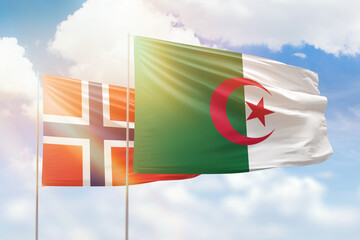 Sunny blue sky and flags of algeria and norway