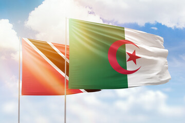 Sunny blue sky and flags of algeria and trinidad and tobago