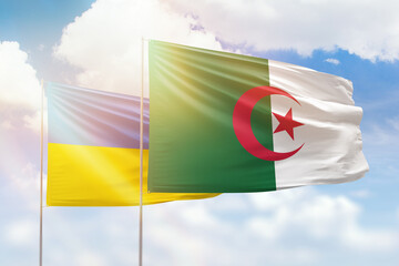 Sunny blue sky and flags of algeria and ukraine