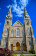 Fototapeta na wymiar Nice and big church under a blue summer sky in Quebec, Canada