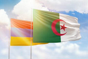 Sunny blue sky and flags of algeria and armenia