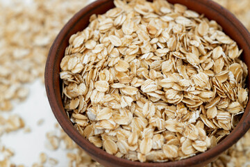 Oat flakes scattered on white background. Copy space, high resolution product