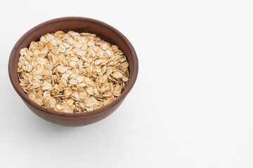 Oat flakes scattered on white background. Copy space, high resolution product