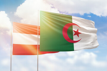 Sunny blue sky and flags of algeria and austria