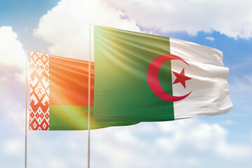 Sunny blue sky and flags of algeria and belarus