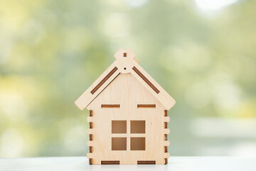 Obraz na płótnie Canvas Mini residential craft house on a green summer background