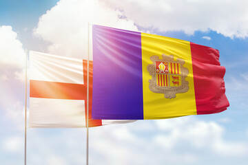 Sunny blue sky and flags of algeria and england