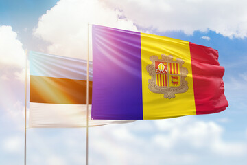 Sunny blue sky and flags of algeria and estonia