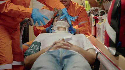 Ambulance paramedic are saving lives by providing oxygen and pumping the heart, providing first aid before the patient is hospitalized.