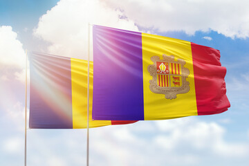 Sunny blue sky and flags of algeria and romania