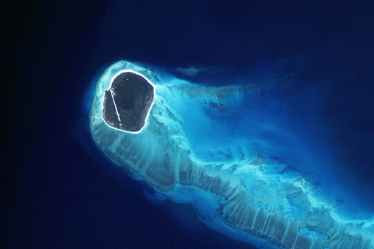 Island in the ocean from space. Elements of this image furnished by NASA