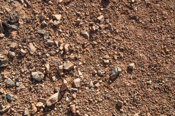 Small stones on the soil. Stone texture on the ground