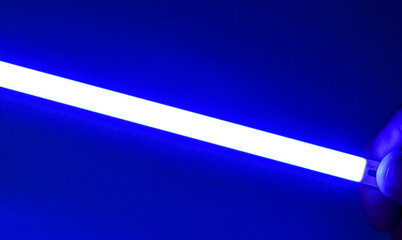 LED blue strip in the darkness - close up photo. Background picture.