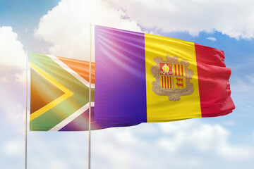 Sunny blue sky and flags of algeria and south africa