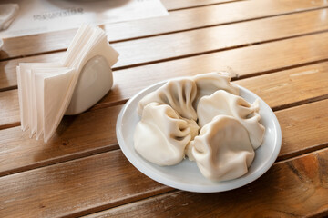 National Georgian cuisine. Khinkali with meat. Khinkali on a wooden board close-up.