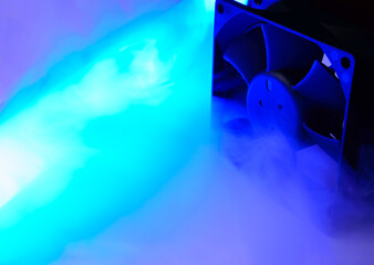 Computer air cooler in a neon blue smoke - close up photo. Background abstract picture.