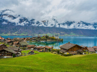 Fototapeta na wymiar Iseltwald village houses on Lake Brienz in Bern, Switzerland
