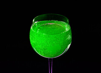 Midori sour cocktail - close up photo in a darkness. Background picture.