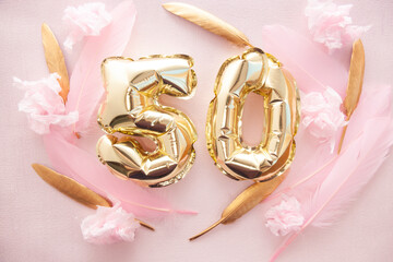 Happy fiftieth birthday with golden number fifty 50 air balloons and feathers with colorful...