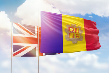 Sunny blue sky and flags of algeria and united kingdom