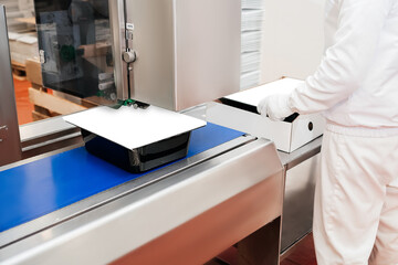 Automated production line in modern food factory.People working.Chicken fillet production line.Production process, packaging on the conveyor line of meat in boxes.Conveyor Belt Food.