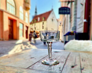 candle on wooden top table at medieval street Tallinn old town Estonia