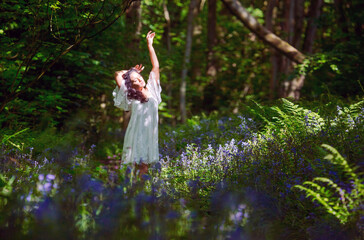 Indian Girl in a white dress walking through a Blue Bell Wood